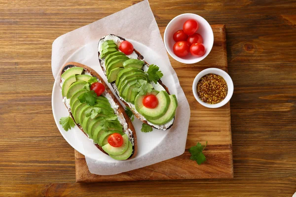 Fresh avocado sandwiches on plate — Stock Photo, Image