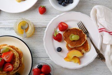 Beyaz ahşap masa üzerinde meyveleri ile Pancakes