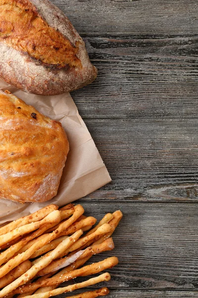 Fresh breads on wood background — Stock Photo, Image