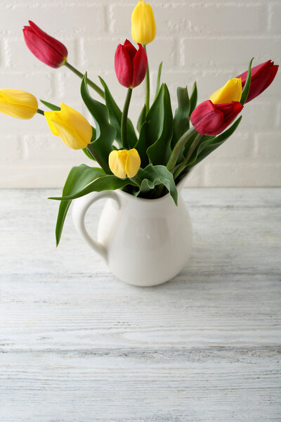 Spring flowers in white pitcher