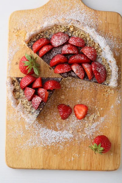 Cutting strawberry tart on board — Stock Photo, Image