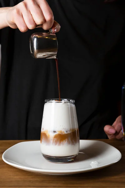 Coffee pouring in cup, making summer coffee