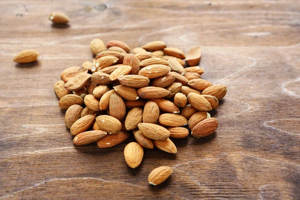 Nuts almonds on wooden surface — Stock Photo, Image