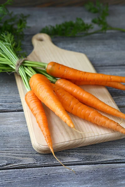 Juicy carrot on the board — Stock Photo, Image