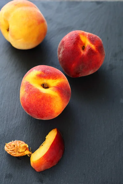 Ripe peaches on slate background — Stock Photo, Image