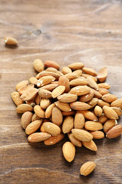 Almonds on wooden surface — Stock Photo, Image