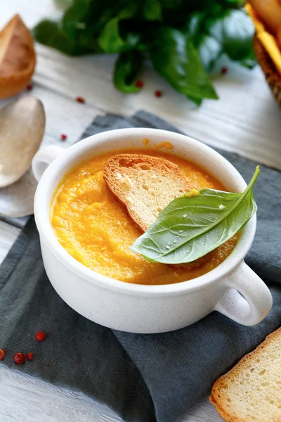 Cream of pumpkin soup with basil leaves — Stock Image Cream of pumpkin soup with basil leaves Stock Photo