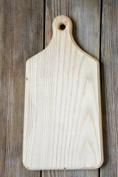 Cutting boards on wooden background — Stock Photo, Image