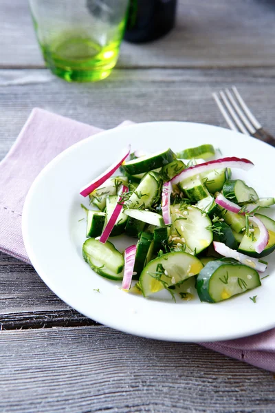 Salad with cucumbers and onions — Stock Photo, Image