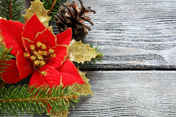 Christmas flower red with bows on a wooden board — Stock Photo, Image