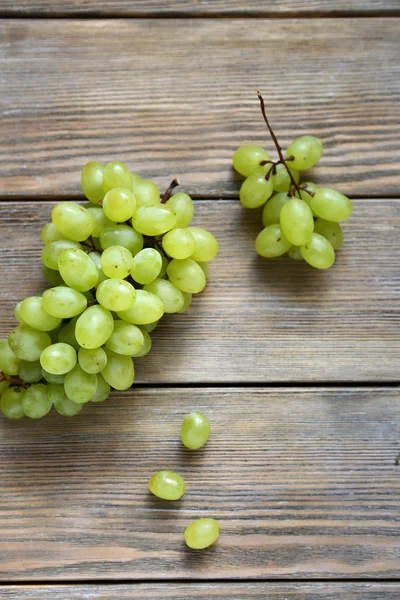 Sweet grapes on wooden boards — Stock Photo, Image