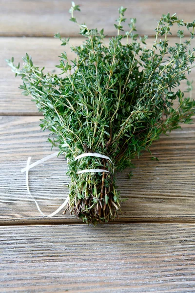 Fragrant thyme on wooden boards — Stock Photo, Image