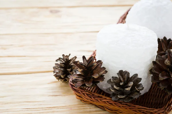 Witte kaarsen in een doos met kegels — Stockfoto