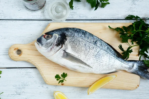 Fresh sea bream and paper — Stock Photo, Image