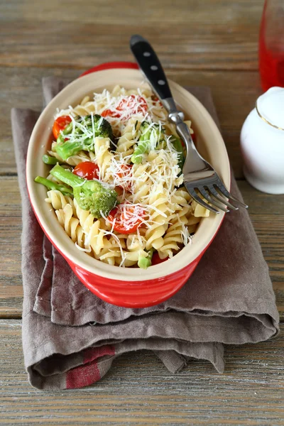 Pasta with broccoli pieces in a dish — Stock Photo, Image