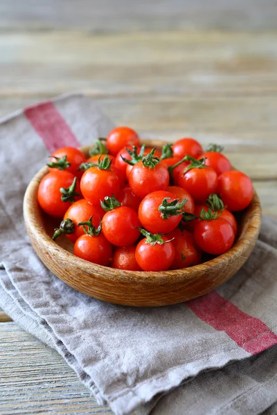 Cherry tomatoes in a wooden bowl — Stock Photo, Image