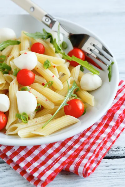 Pasta penne with cherry tomatoes and mozzarella cheese — Stock Photo, Image
