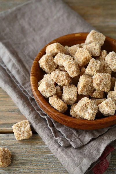 Sugar cubes in a small wooden bowl — Stock Photo, Image