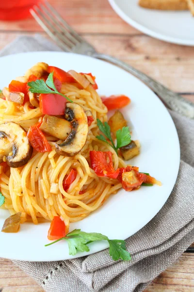 Spaghetti with vegetables on a white plate — Stock Photo, Image