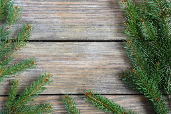 Frame met Kerstmis pine branch op planken — Stockfoto