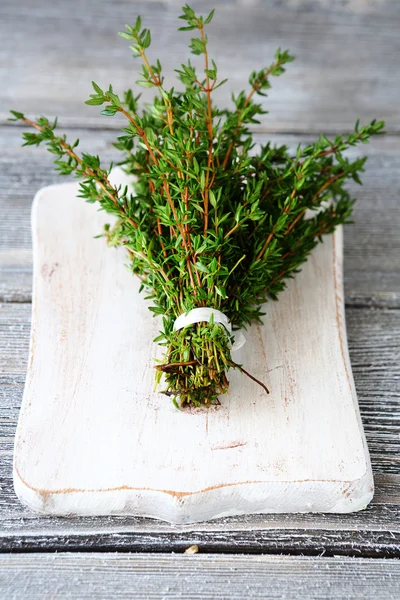 Fragrant thyme on cutting board — Stock Photo, Image