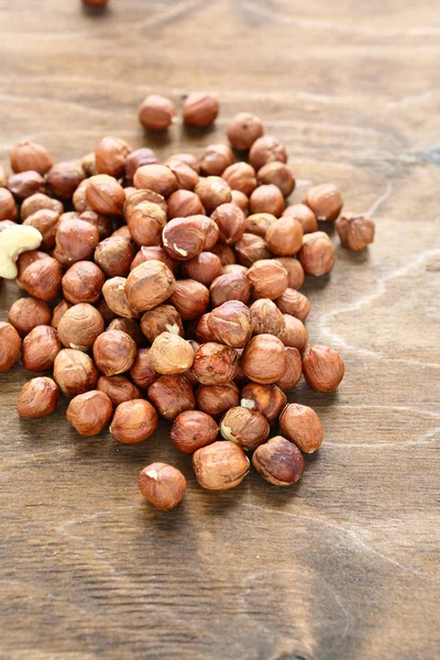 Delicious hazelnuts on wooden surface — Stock Photo, Image