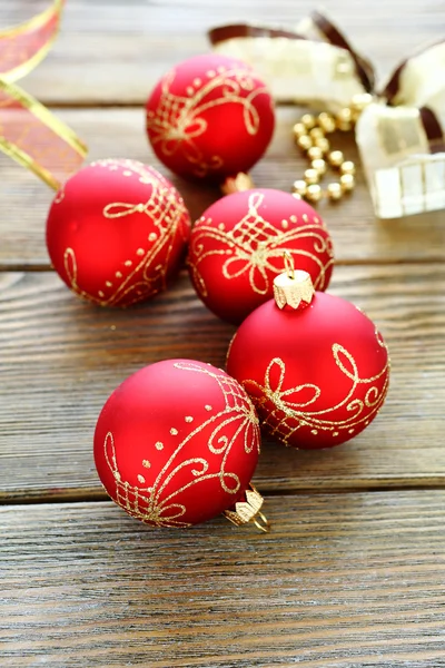 Christmas balls with ribbon on wooden boards — Stock Photo, Image