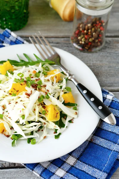 Салат из капусты и апельсин на белой тарелке — стоковое фото