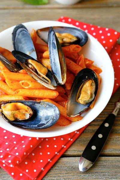 Pasta with mussels on a white plate — Stock Photo, Image