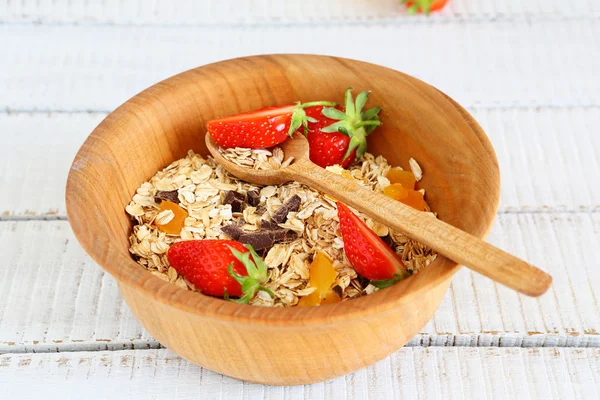 Flakes with strawberries and dried apricots  on wooden boards — Stock Photo, Image