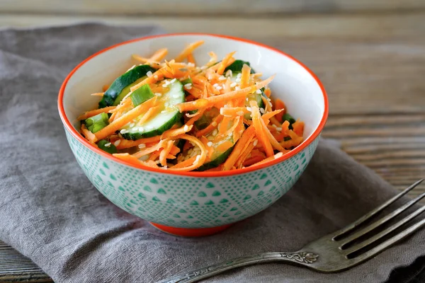 Вегетарианский салат с морковью и огурцами в миске — стоковое фото