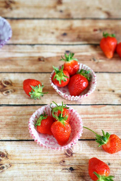 Strawberries in paper forms for cupcakes — Stock Photo, Image