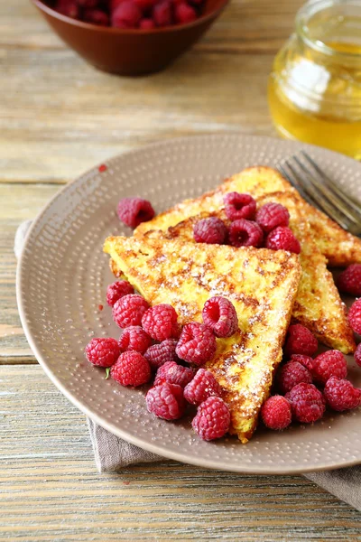 French toast with raspberries and honey on a plate — Stock Photo, Image