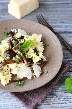 Pasta with mushrooms on a plate clipart
