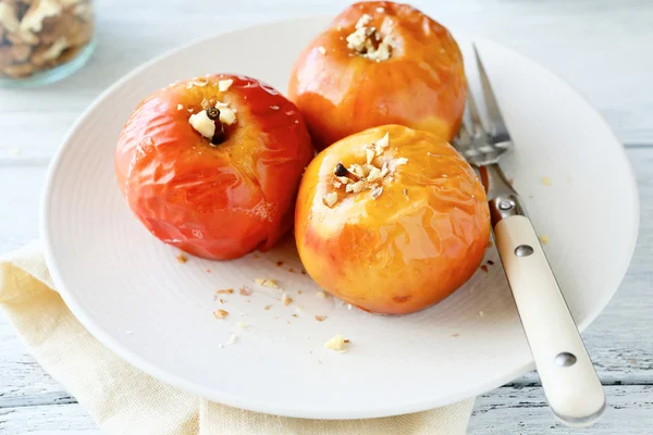 Manzanas con nueces en un plato blanco —  Fotos de Stock