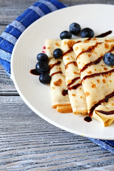 Sweet crepes with chocolate sauce — Stock Photo, Image