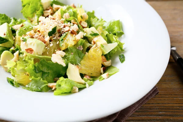 Fresh salad with avocado, lettuce, orange and crushed nuts — Stock Photo, Image