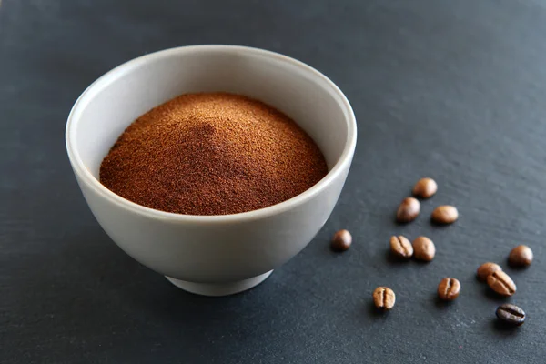 Ground coffee in bowl on a slate — Stock Photo, Image