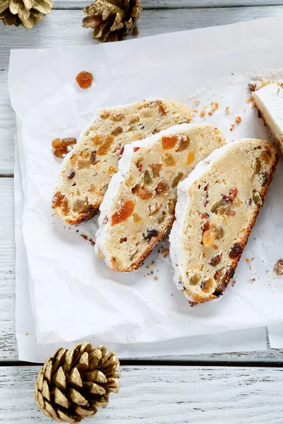 Tasty Stollen pieces of on white paper — Stock Photo, Image