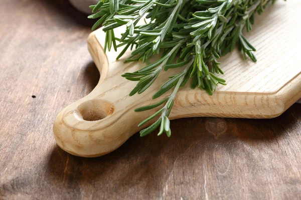 Fragrant rosemary on a cutting board — Stock Photo, Image