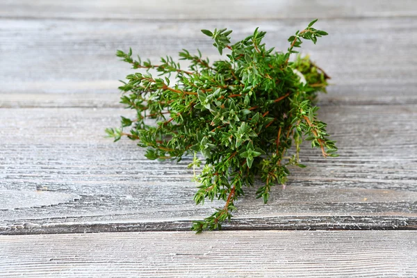 Bunch of thyme on wooden boards — Stock Photo, Image