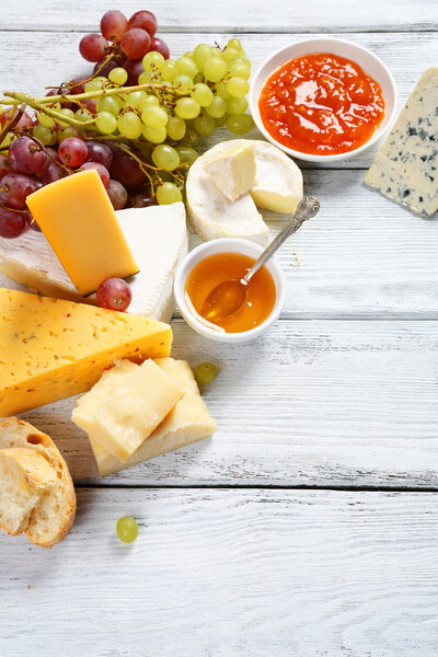 Delicious cheeses with honey and grapes