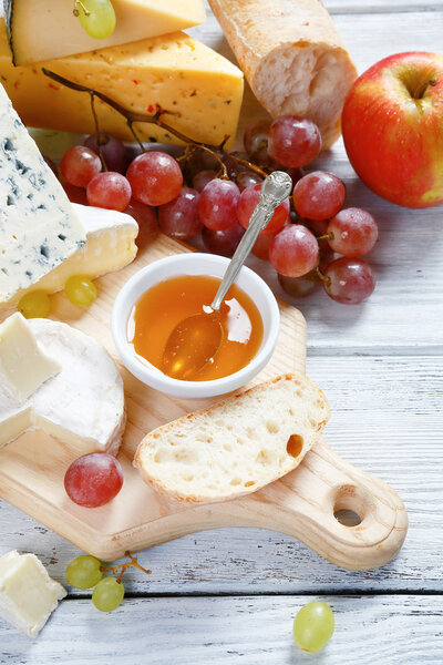 Pieces of different kinds cheese with grapes