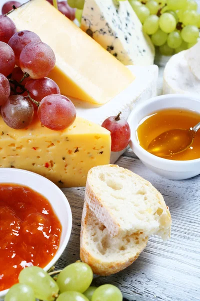 Tasty cheese on a board with jam — Stok fotoğraf