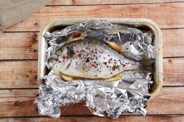 Cooked dorado on the foil clipart