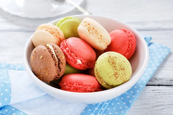 Macaroon in a bowl on blue napkin — Stock Photo, Image