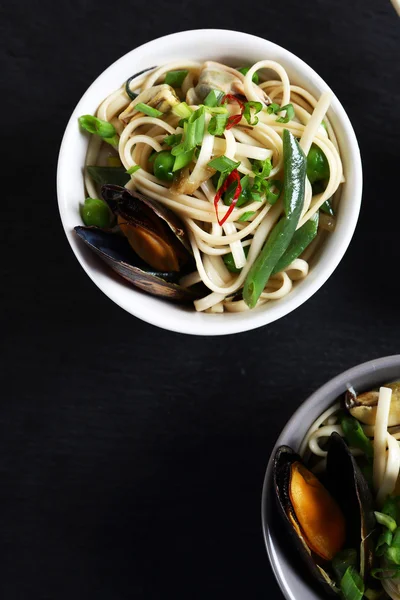 Noodles with seafood in two bowls — Stock Photo, Image