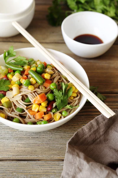 Noodles with vegetables in a white bowl — Stock Photo, Image