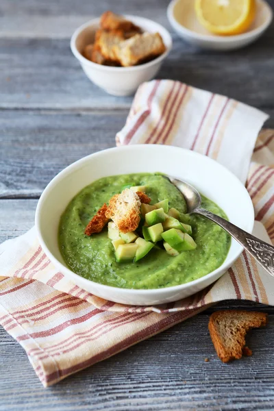 Cold avocado cream-soup in white bowl — Stock Photo, Image