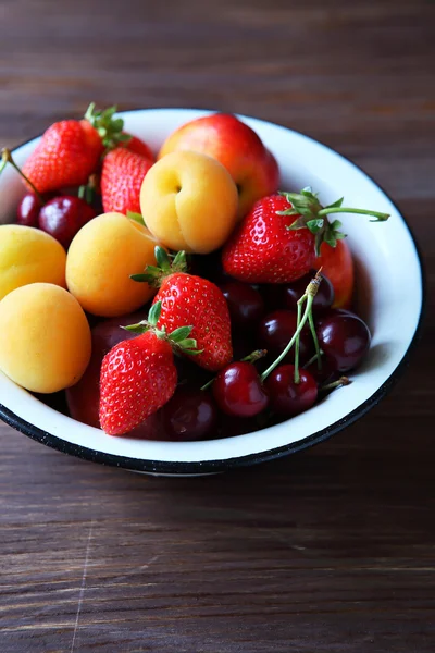 Fresh fruits in white bowl — Stock Photo, Image